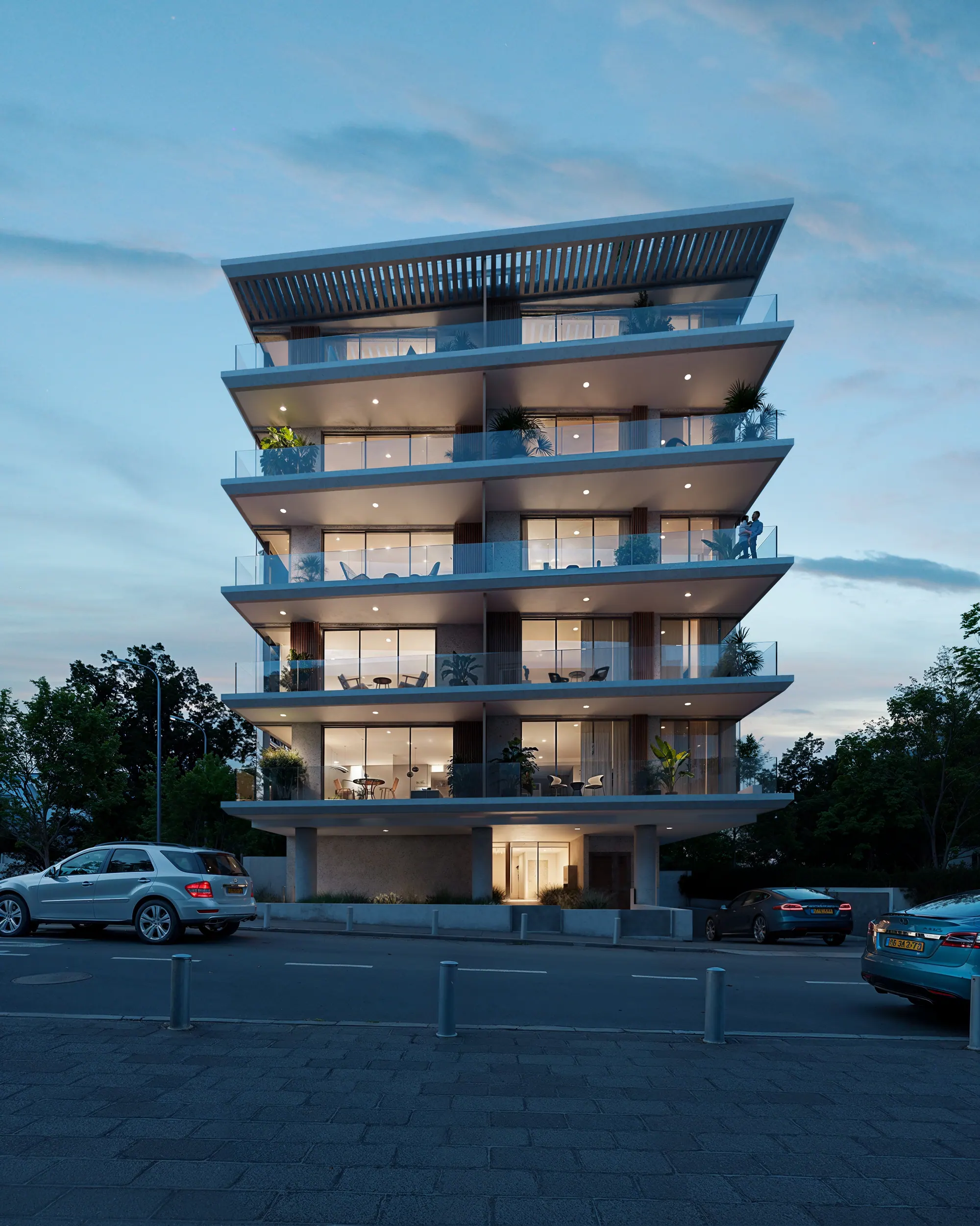 Kalischer 38 seen from the street at dusk, the apartments lit from within